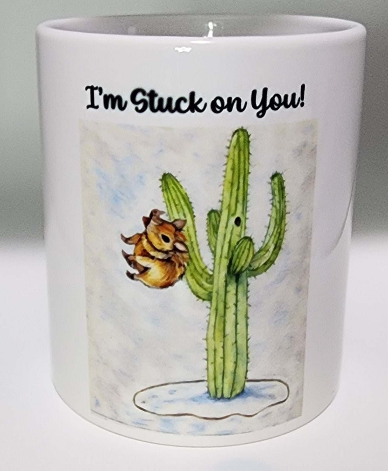 A Javelina is stuck on a Saguaro Cactus. The title on the mug says "Stuck on You!"